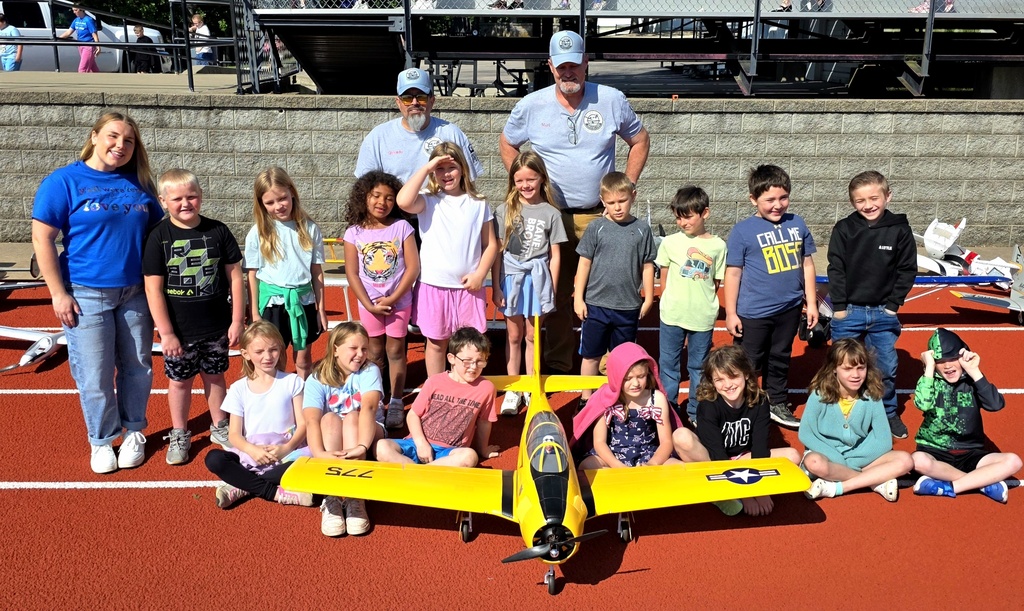 Zoom with second grade. Students pose with RC Plane. 