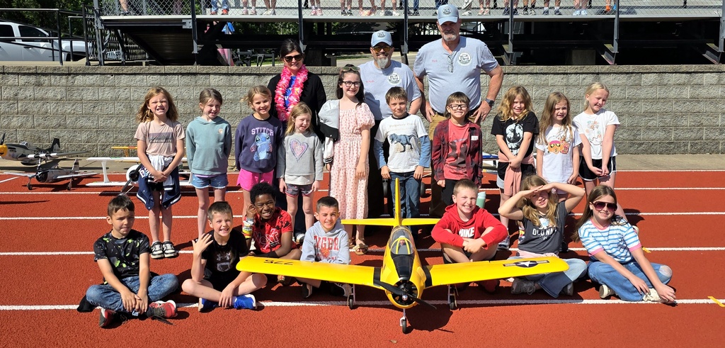 Zoom with second grade. Students pose with RC Plane. 