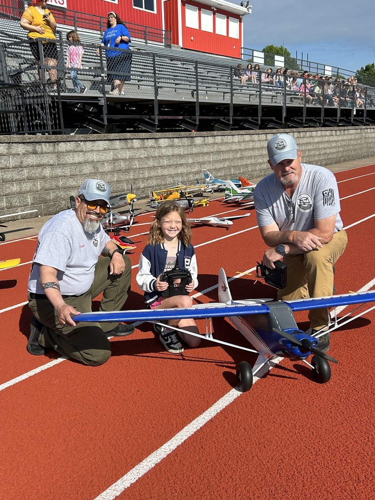 Zoom with second grade. Students pose with RC Plane. 