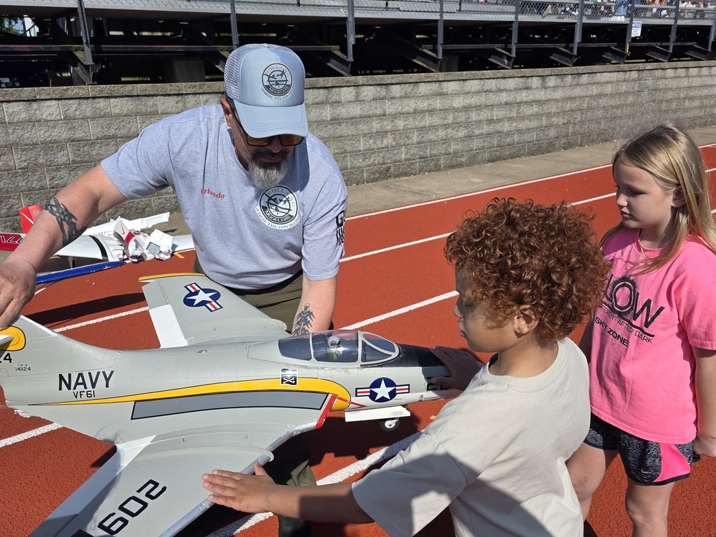 Zoom with second grade. Students pose with RC Plane. 