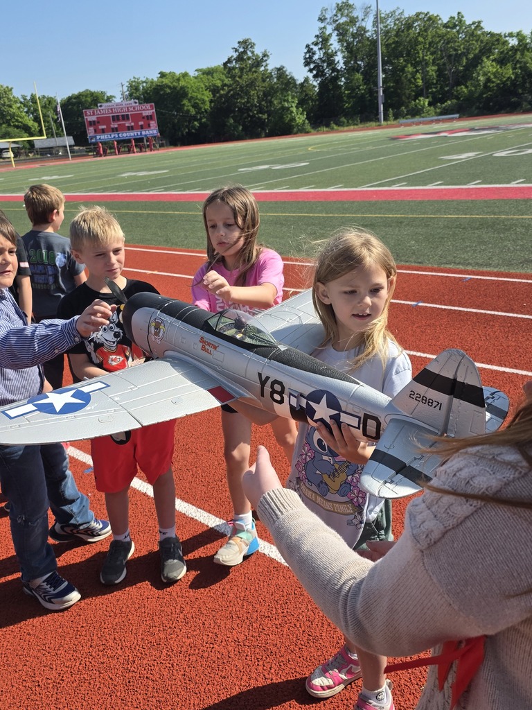 Zoom with second grade. Students pose with RC Plane. 