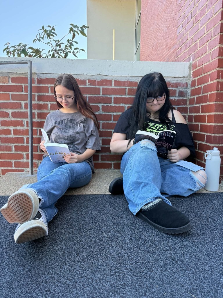 Great Books class reads outside.
