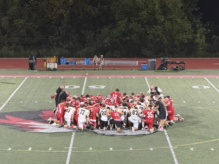 players and coaches at midfield 