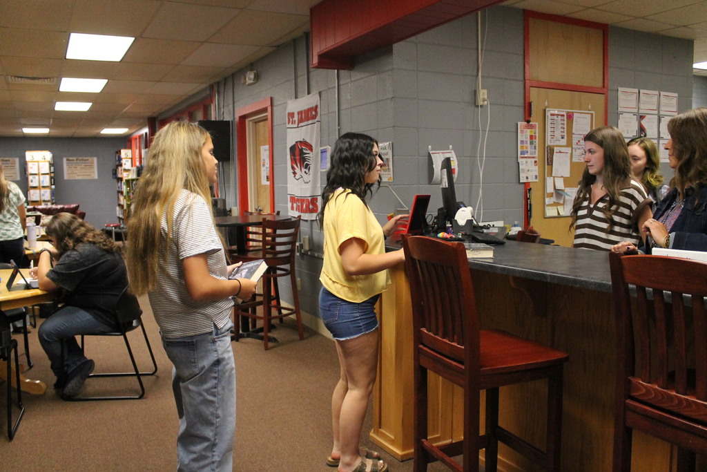 Students checking out books.