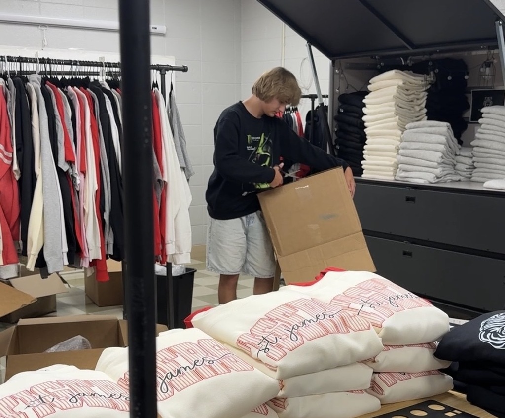 Tiger Express Apparel staff work on new storefront location. 