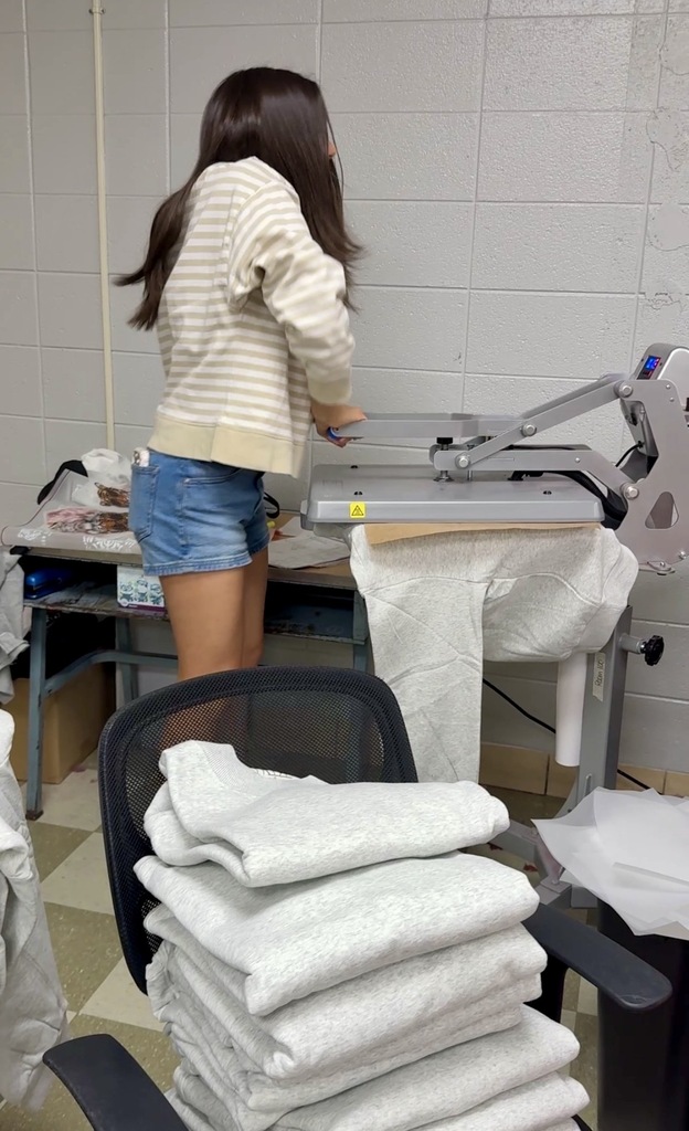 Tiger Express Apparel staff work on new storefront location. 