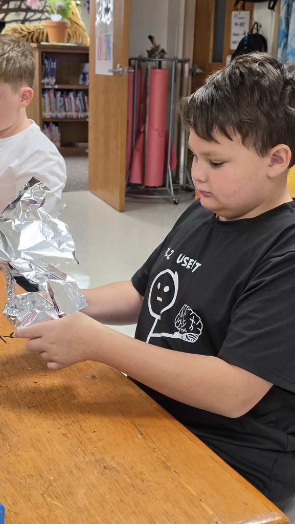 Fifth grade students work in art class on sculptures.