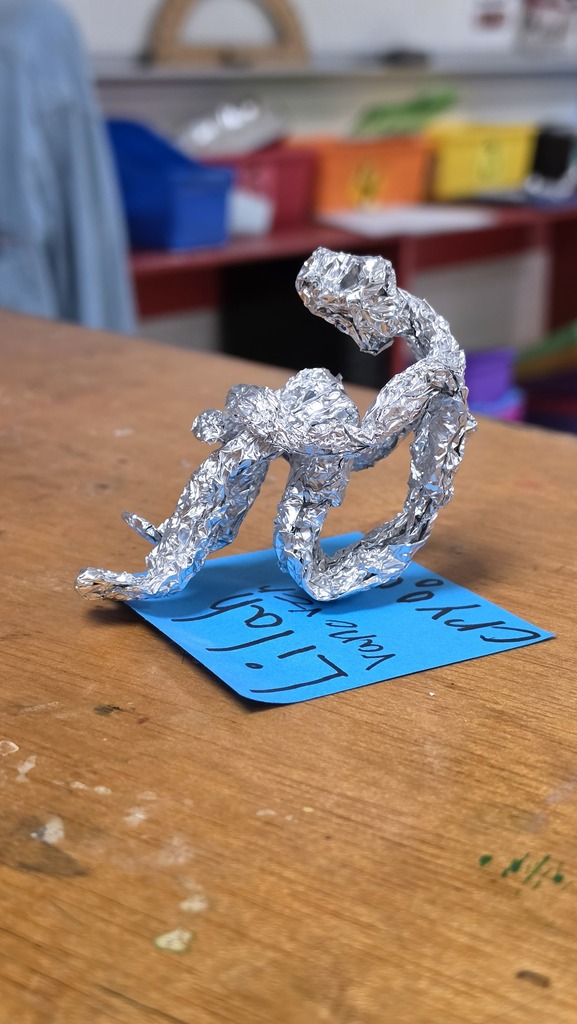 Fifth grade students work in art class on sculptures.
