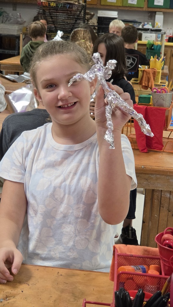 Fifth grade students work in art class on sculptures.