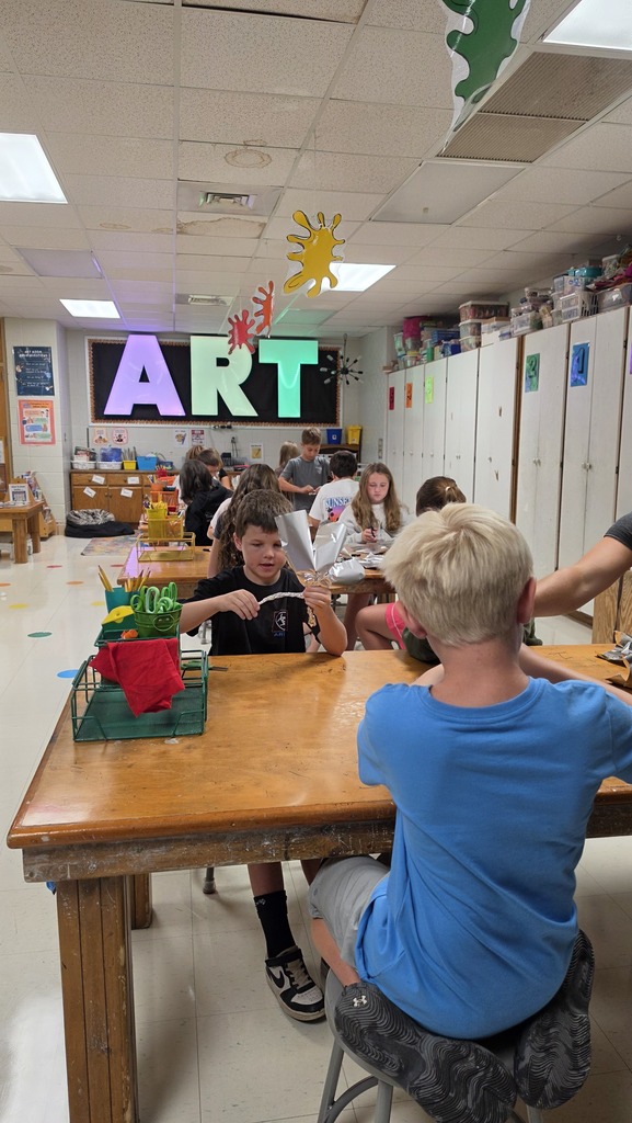 Fifth grade students work in art class on sculptures.