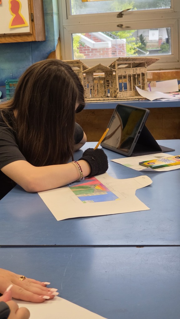 Students create three dimensional art at the high school.