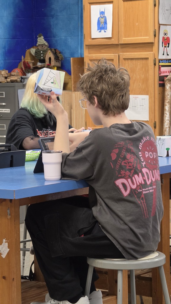 Students create three dimensional art at the high school.