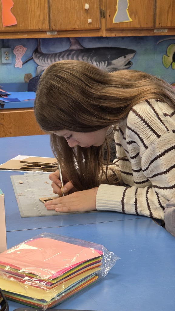 Students create three dimensional art at the high school.