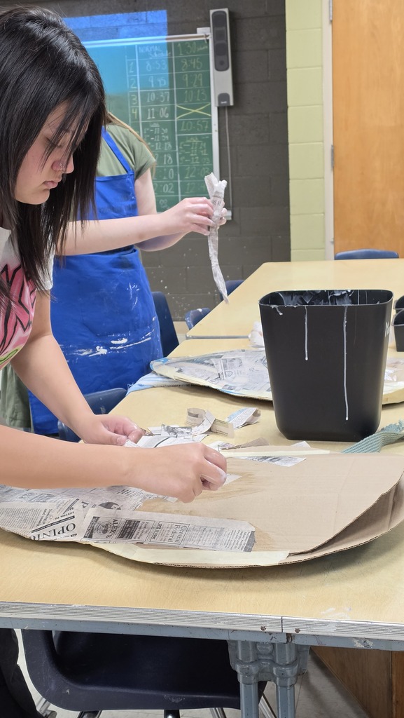 Advanced art students create props for the Red Regiment's show.