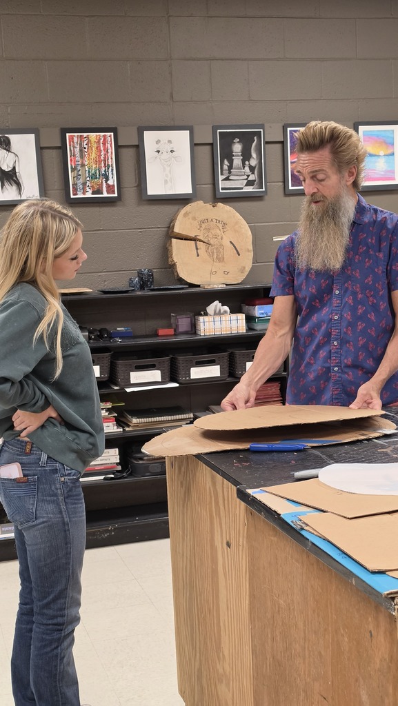 Advanced art students create props for the Red Regiment's show.