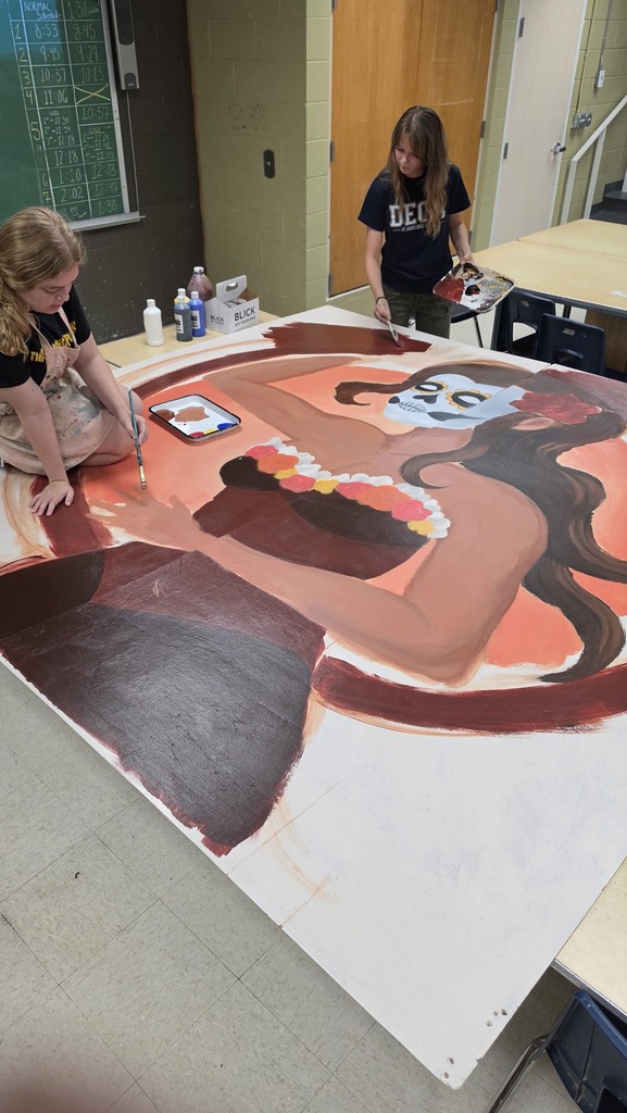 Advanced art students create props for the Red Regiment's show.