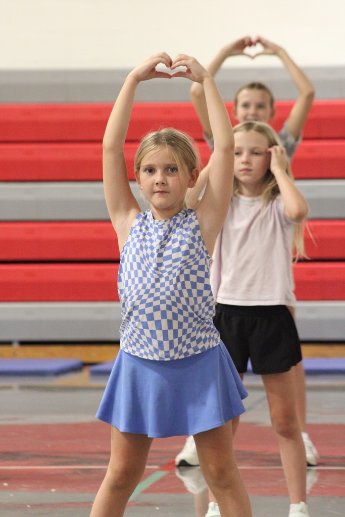 Cheer camp showcases Social Integrity through mentorship. 