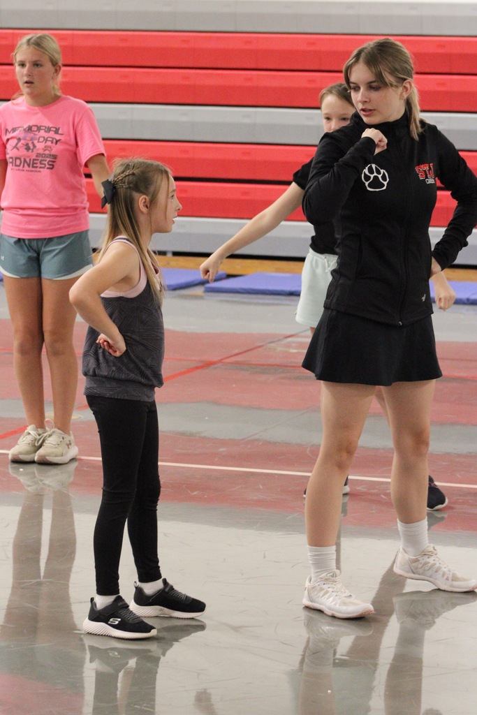 Cheer camp showcases Social Integrity through mentorship. 