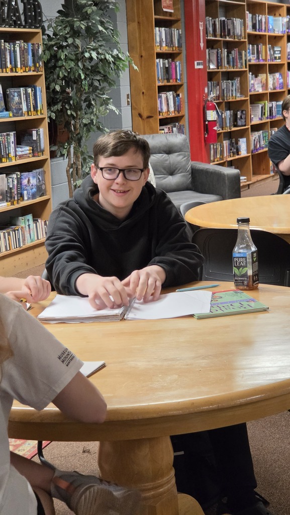 Creative writing students visit the library for a lesson about short form writing.
