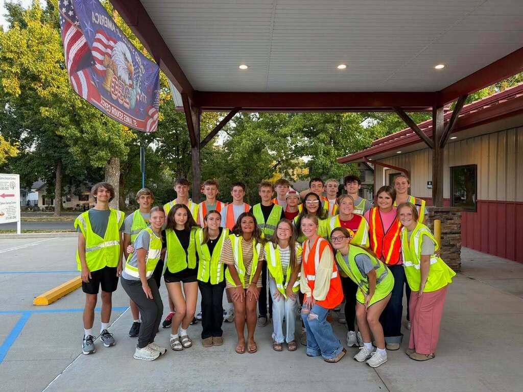 St. James Cross Country, vollyeball, and softball team members volunteer at Commodity Distribution.