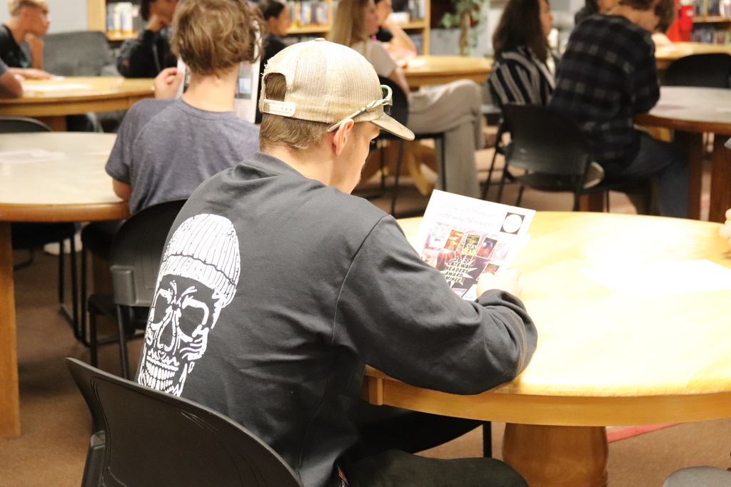 Student looking at flyer of Gateways