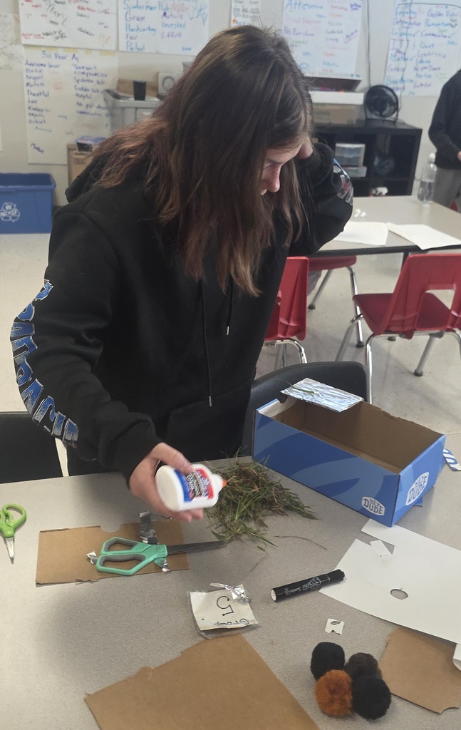 Middle school agriculture students build models to display their research.