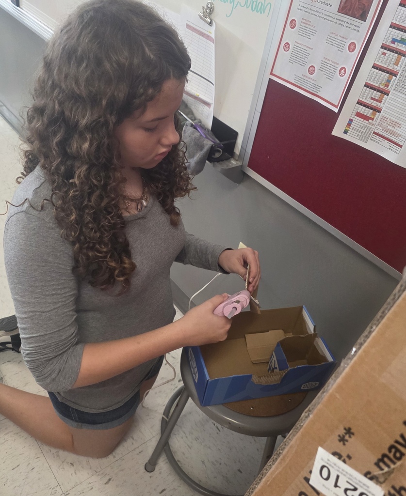 Middle school agriculture students build models to display their research.