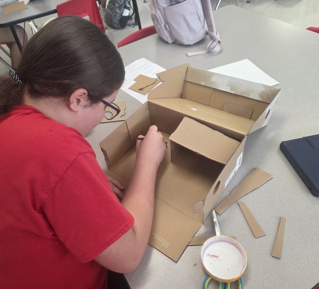 Middle school agriculture students build models to display their research.