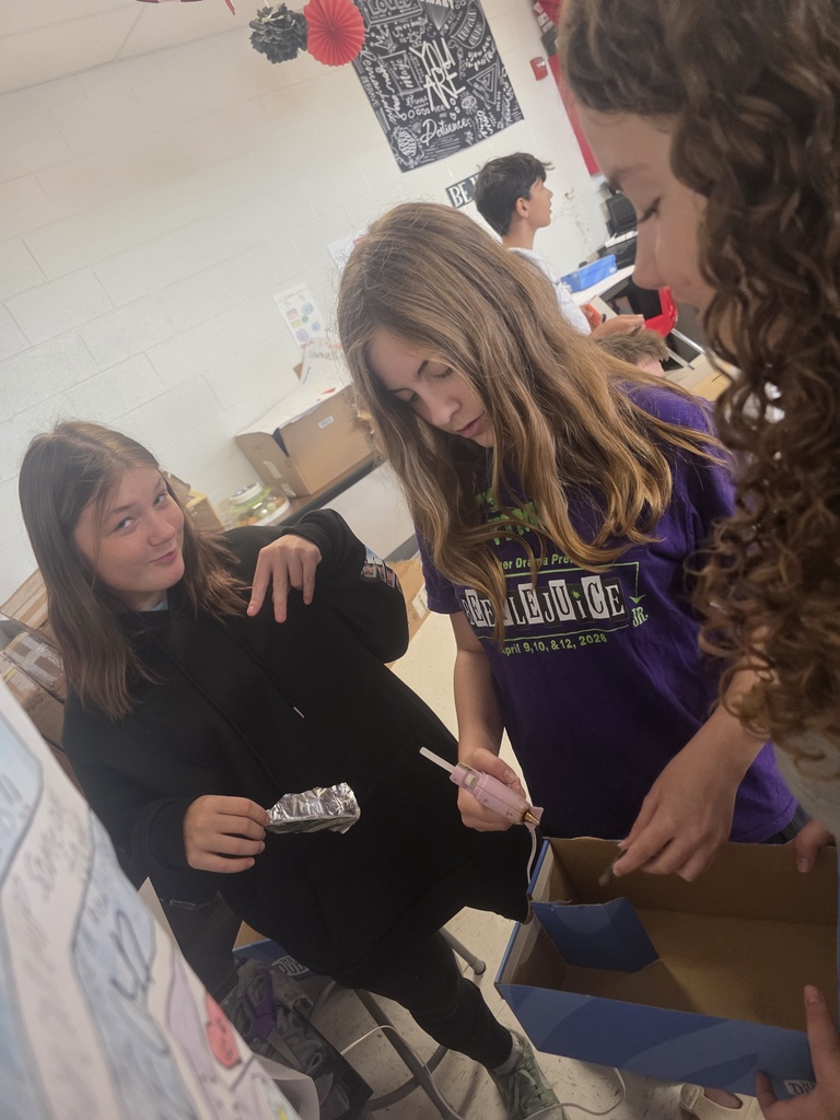 Middle school agriculture students build models to display their research.
