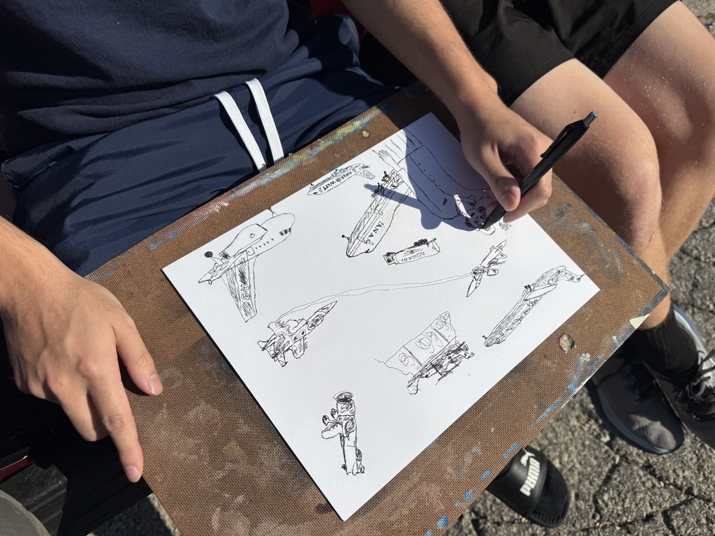High school artists enjoy the Fall weather while sketching their design for Inktober.