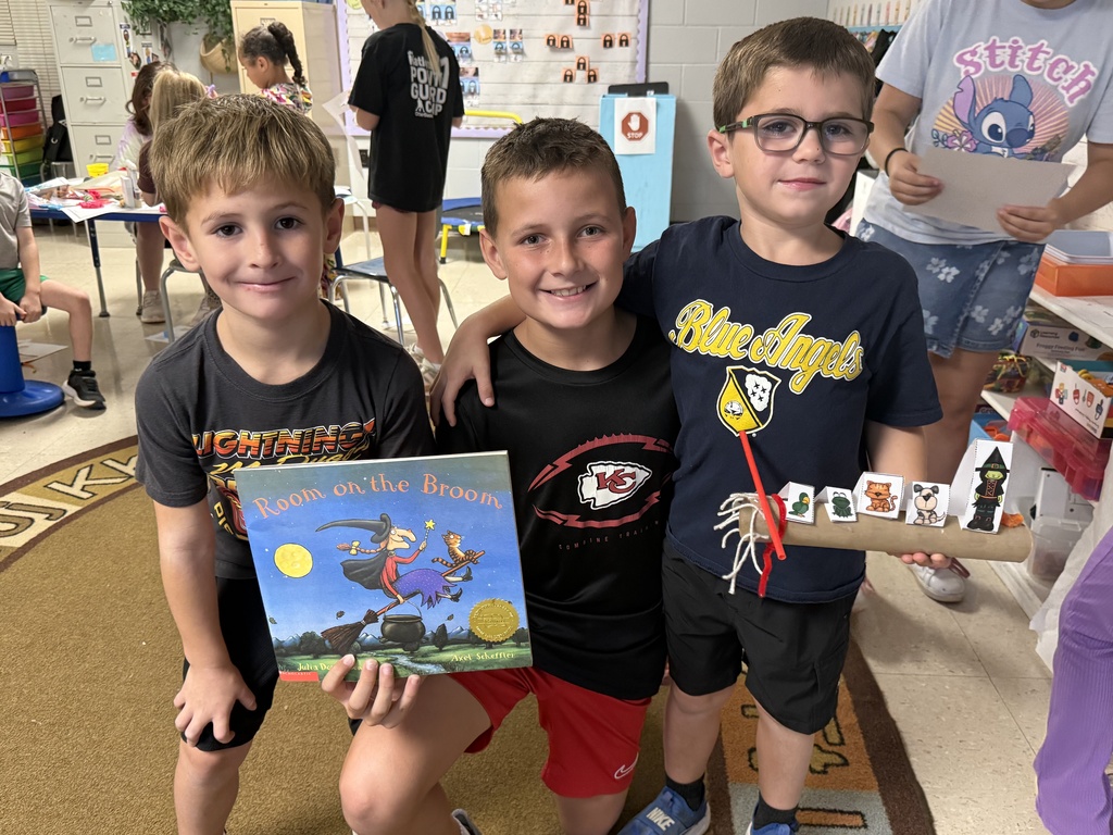 Fifth-grade students help kindergarten students build their own brooms during a Halloween-themed STEM challenge after reading Room on the Broom.