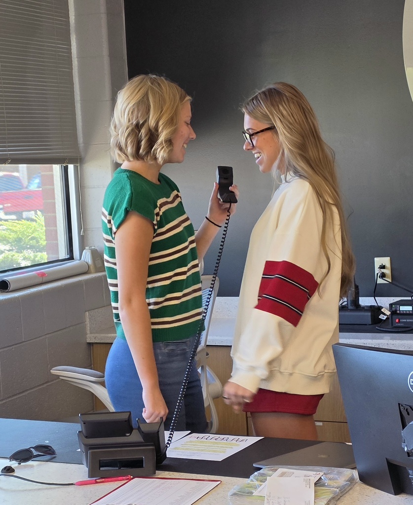Students read the daily announcements at St. James high school.