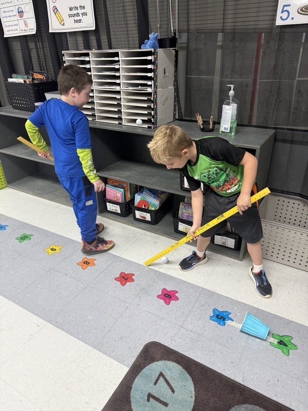 Kindergarten students learn about force and motion by measuring length of ping pong ball.