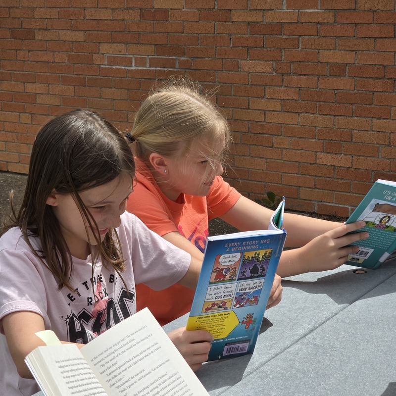 Girls reading at table