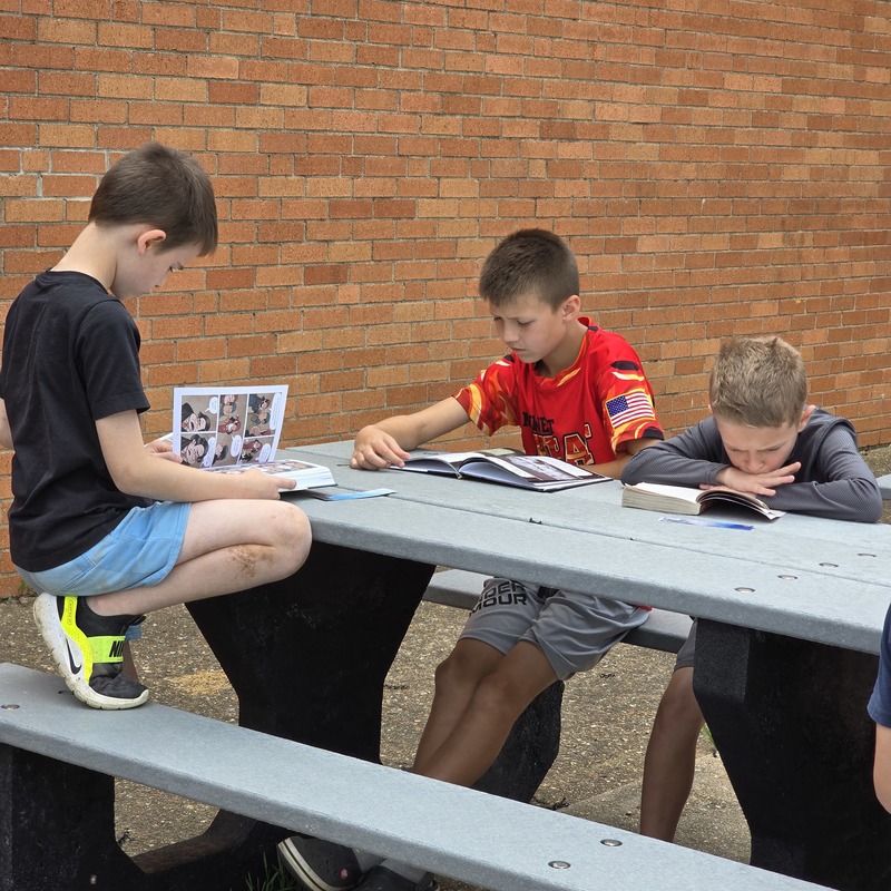 boys reading at table