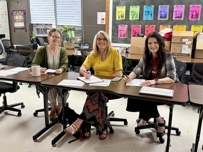 District administrators sit and are ready to judge presentations. 