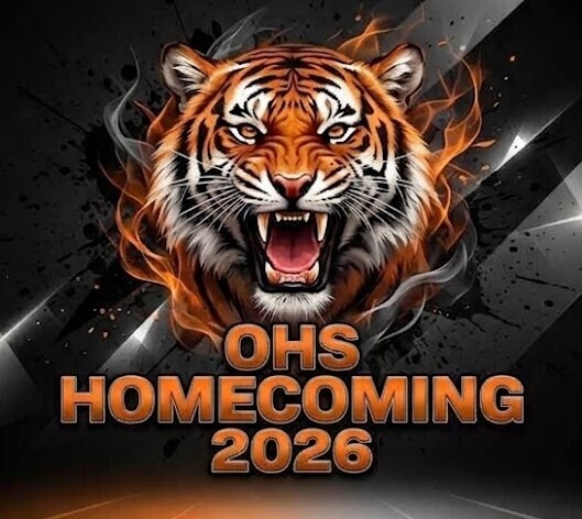 A dramatic, dark-themed graphic featuring a roaring tiger with glowing orange eyes and sharp teeth at the top. The bold, layered text reading "OHS HOMECOMING 2026" is centered below the tiger in orange with a dark outline. Dynamic black, gray, and white geometric lines, smoke effects, and subtle light streaks frame the image against a dark background.