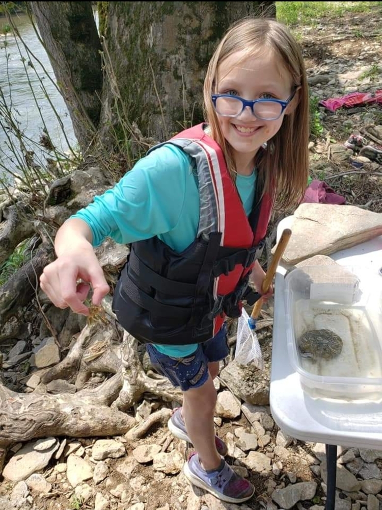 kid holding crawdad