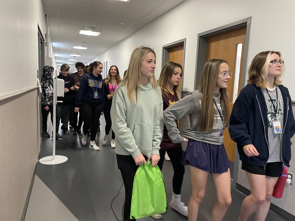 A group of 8th graders walk down a hallway at SC4 during the annual tour event