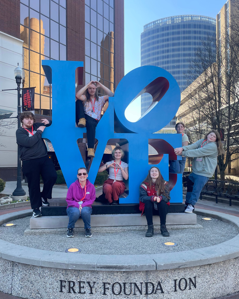 TEC students pose on "LOVE" sign in Grand Rapids