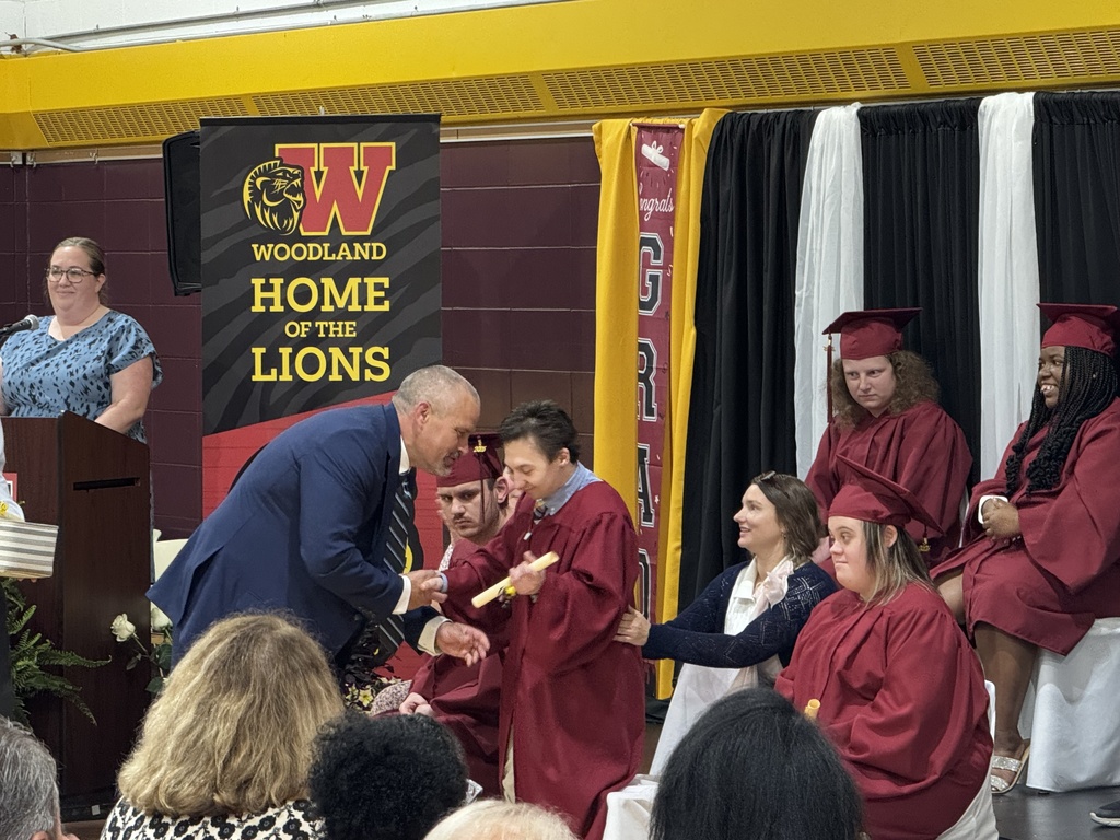 Assistant principal Ethan Barden shakes hands with a Woodland student