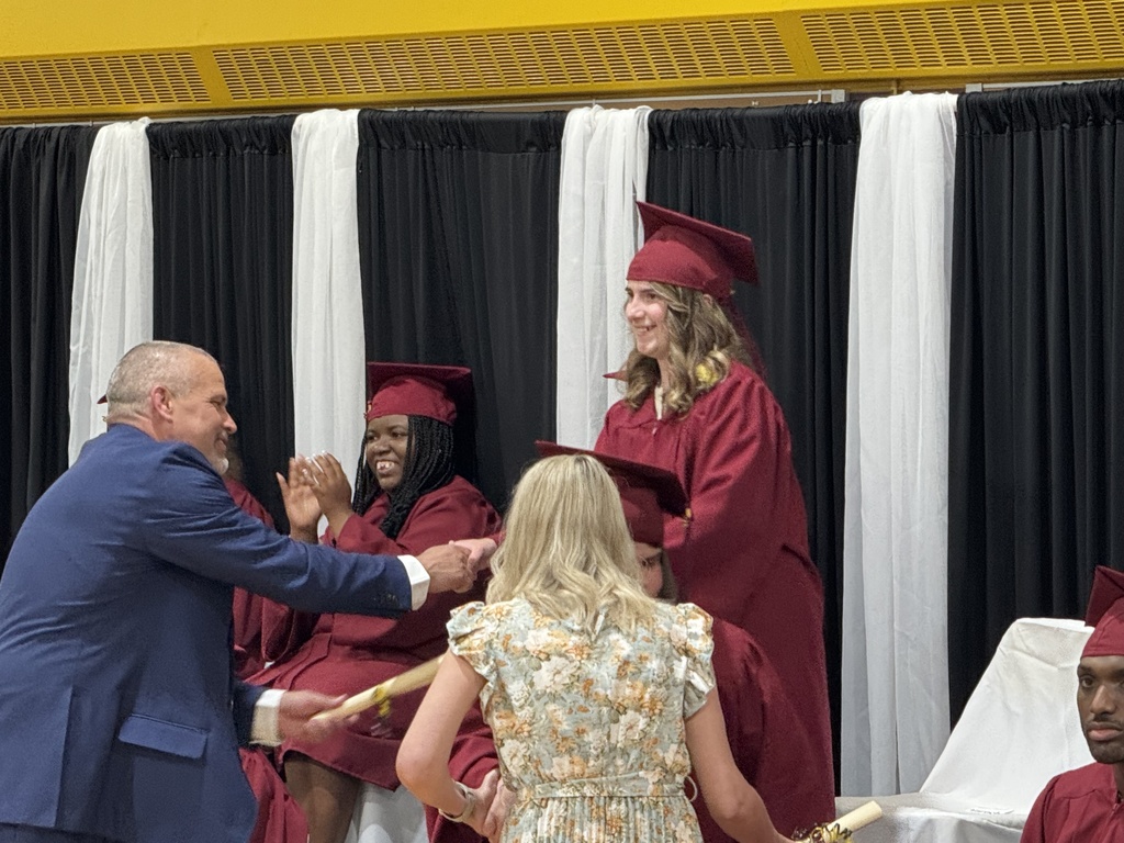 Assistant principal Ethan Barden shakes hands with a Woodland student