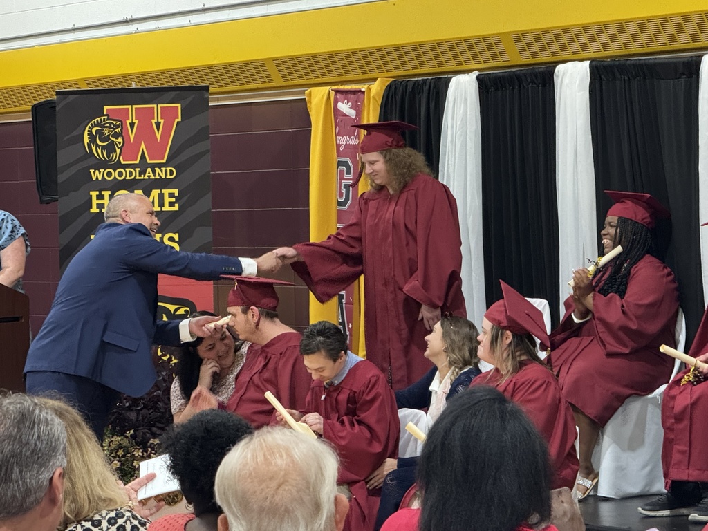 Assistant principal Ethan Barden shakes hands with a Woodland student