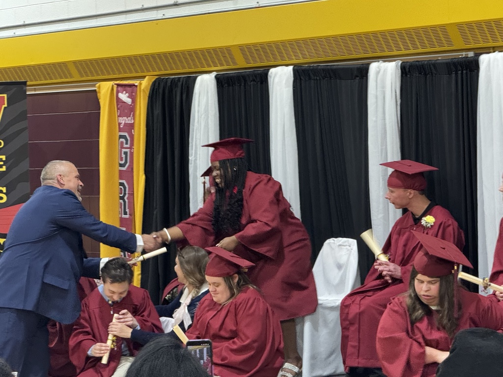 Assistant principal Ethan Barden shakes hands with a Woodland student