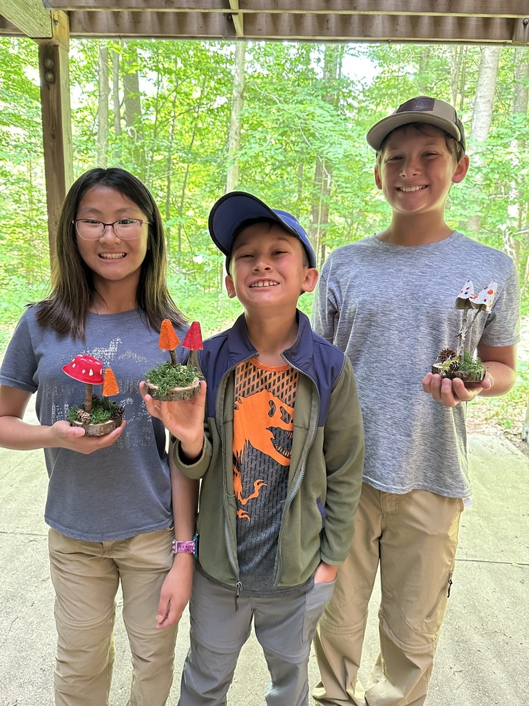 Three students hold their fungi creations