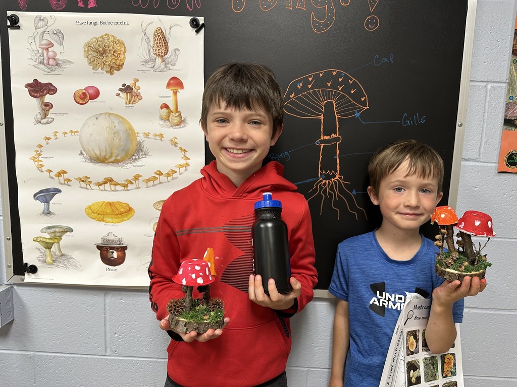 Two students hold up their fungi creations