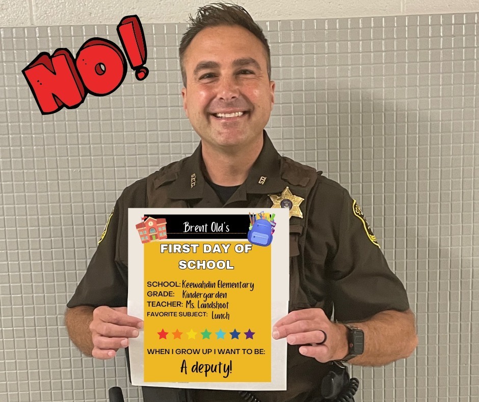 Deputy holding a "First Day of School" sign