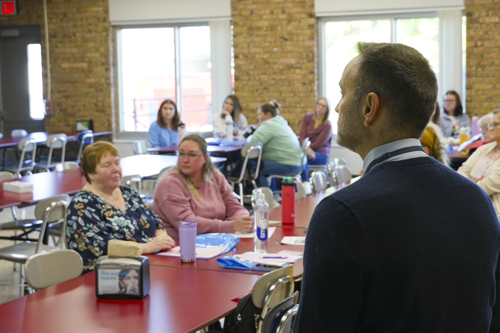  A presenter talks to a room of people