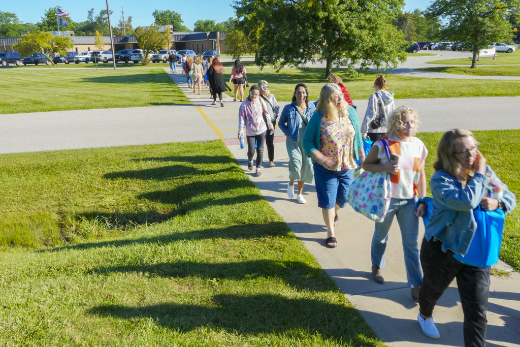 A group of people walking the sidewalk on the RESA campus