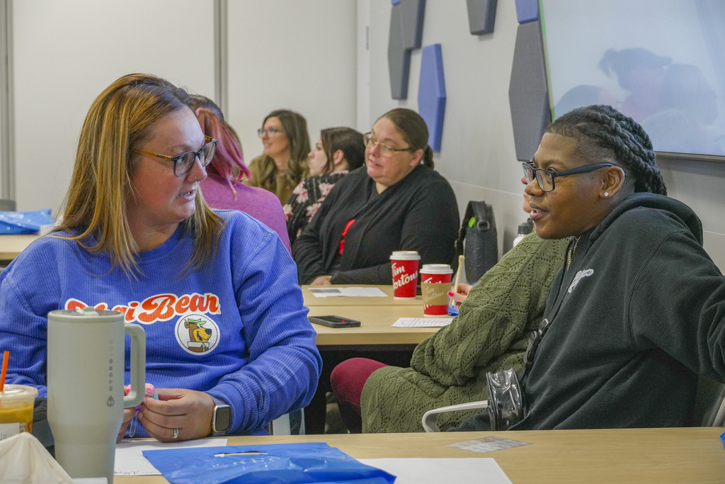 Two people sitting at a table having a conversation